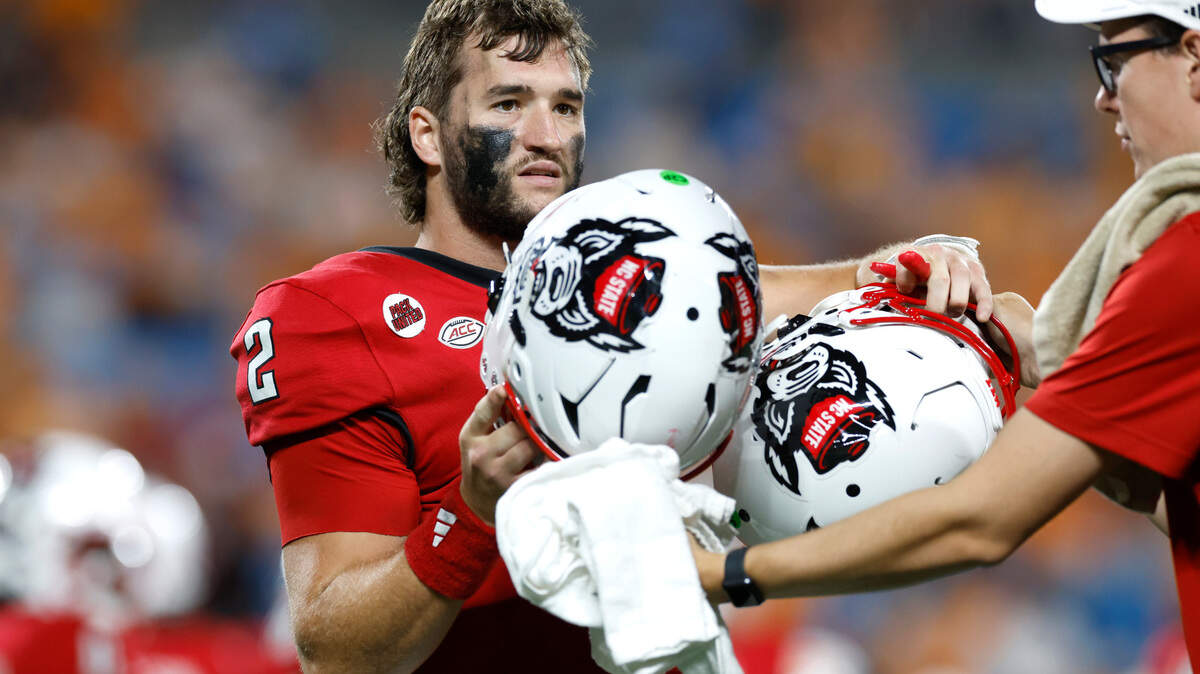 N.C. State quarterback Grayson McCall (2) switches helmets during the second half of Tennessee’s 51-10 victory over N.C. State in the Duke’s Mayo Classic at Bank of America Stadium in Charlotte, N.C., Saturday, Sept. 7, 2024.