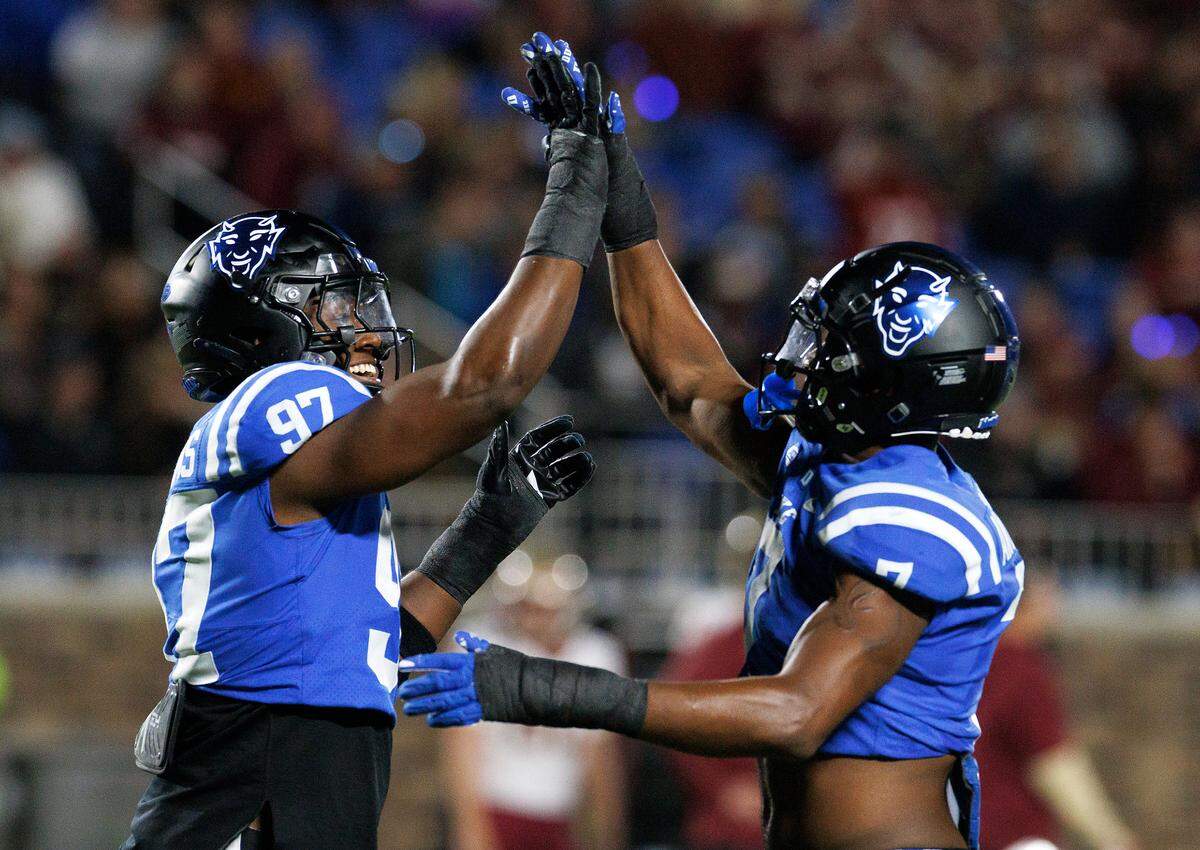 Duke’s Wesley Williams and Vincent Anthony Jr. celebrate following a defensive stop during the first half of the Blue Devils’ game against Florida State on Friday, Oct. 18, 2024, at Wallace Wade Stadium in Durham, N.C.