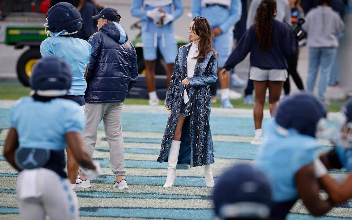 Jordon Hudson, girlfriend of UNC football coach Bill Belichick (left, in dark blue parka) on the field during UNC football’s Practice Like a Pro open practice at Kenan Stadium in Chapel Hill, N.C., Saturday, April 12, 2025.