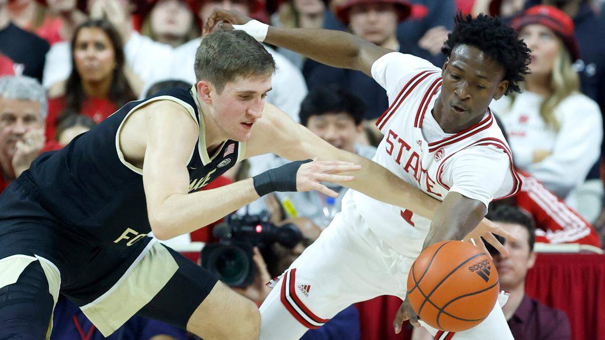 N.C. State’s Jarkel Joiner (1) steals the ball from Wake Forest’s Andrew Carr (11) during the first half of N.C. State’s game against Wake Forest at PNC Arena in Raleigh, N.C., Wednesday, Feb. 22, 2023.