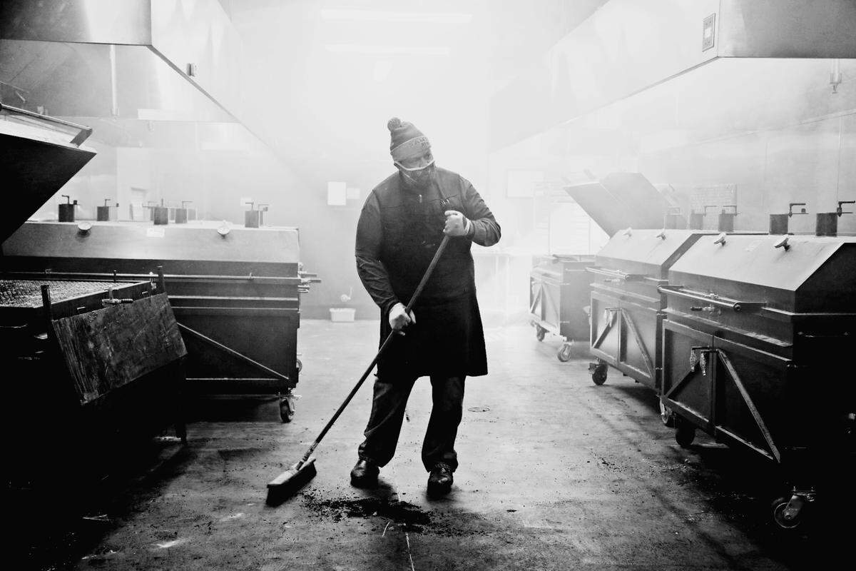 Sam Jones BBQ pit crew member Tiny Townsend works in the smokehouse in the new downtown Raleigh location on Wednesday morning, Feb. 3, 2021. The restaurant is starting off with a soft-open this week.