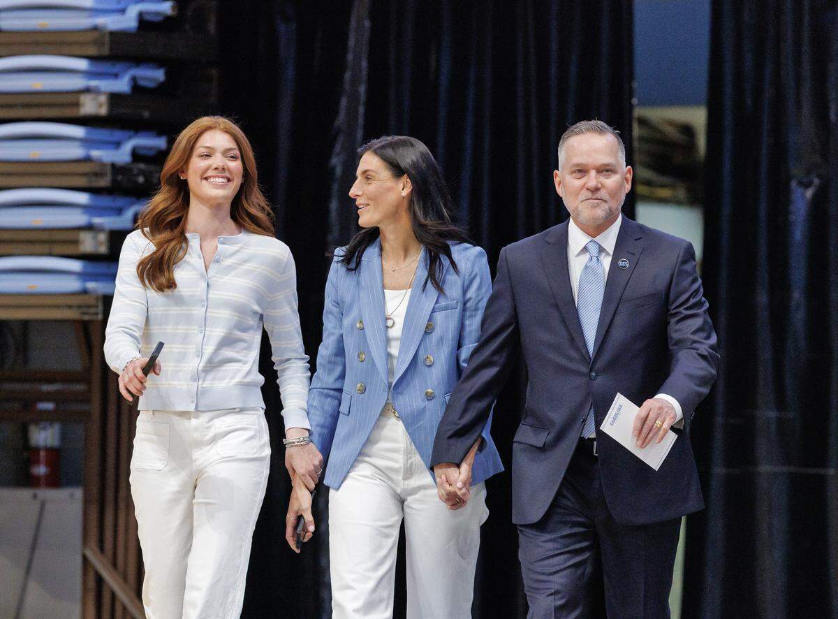 New North Carolina men’s basketball head coach Michael Malone arrives with his daughter, Bridget, and wife, Jocelyn, to an introductory press conference at the Smith Center on Tuesday, April 7, 2026, in Chapel Hill, N.C.