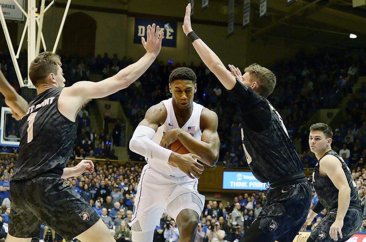 Duke forward R.J. Barrett (5) attempts to move past Army guard Jordan Fox (1) and  guard Jacob Kessler (10) in the first half. Duke defeated Army 94-72 at Cameron Indoor Stadium In Durham, N.C. Sunday, Nov. 11, 2018.