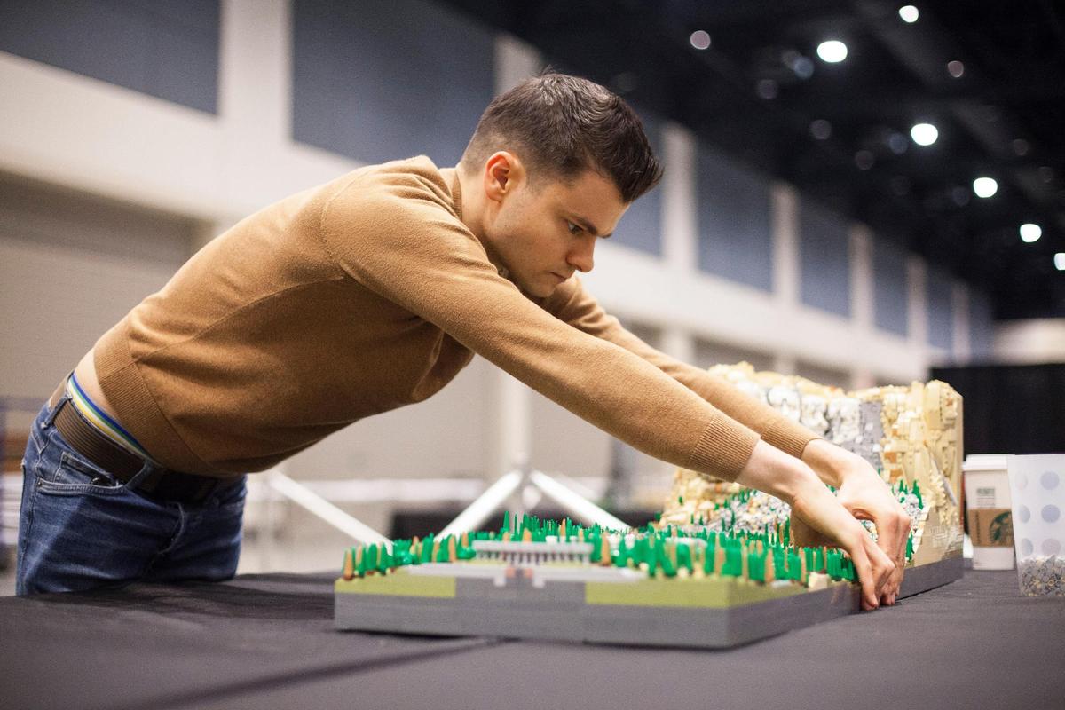 Rocco Buttliere, an architect from Chicago, finishes piecing together a LEGO version of Mount Rushmore on Friday, March 8, 2019 that he built over the course of eight weeks. Buttliere brought the piece, and many others, to Raleigh for this weekend’s BrickUniverse LEGO fan convention at the Raleigh Convention Center.
