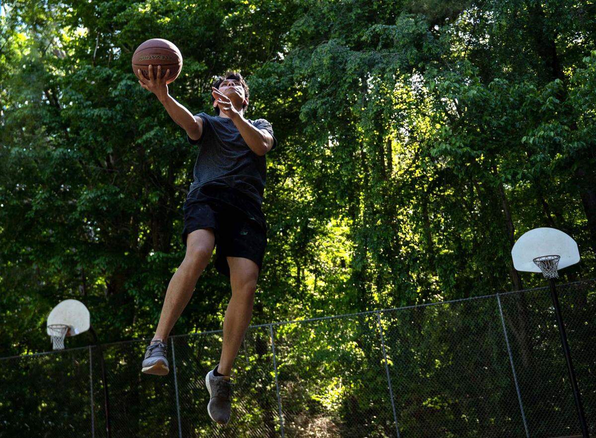 Yso Nieya shoots a layup at the basketball hoops outside the Sertoma Art Center on Tuesday, May 10, 2022.