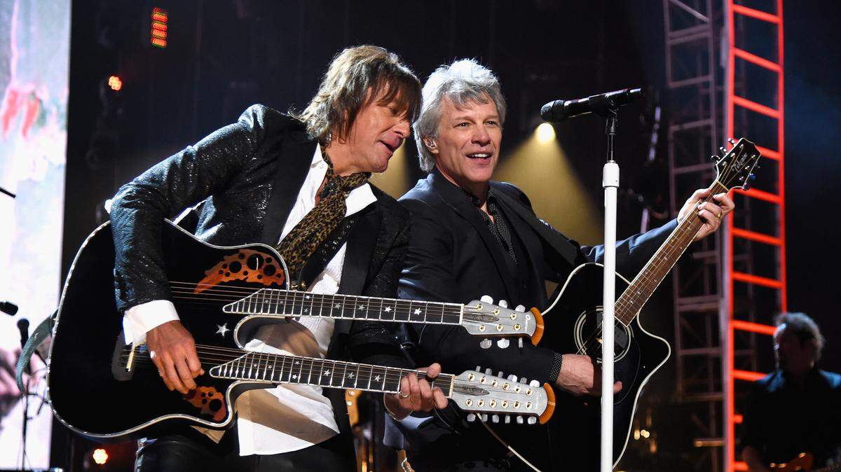 Richie Sambora, left, and Jon Bon Jovi of Bon Jovi perform at the band's induction into the 2018 Rock and Roll Hall of Fame.