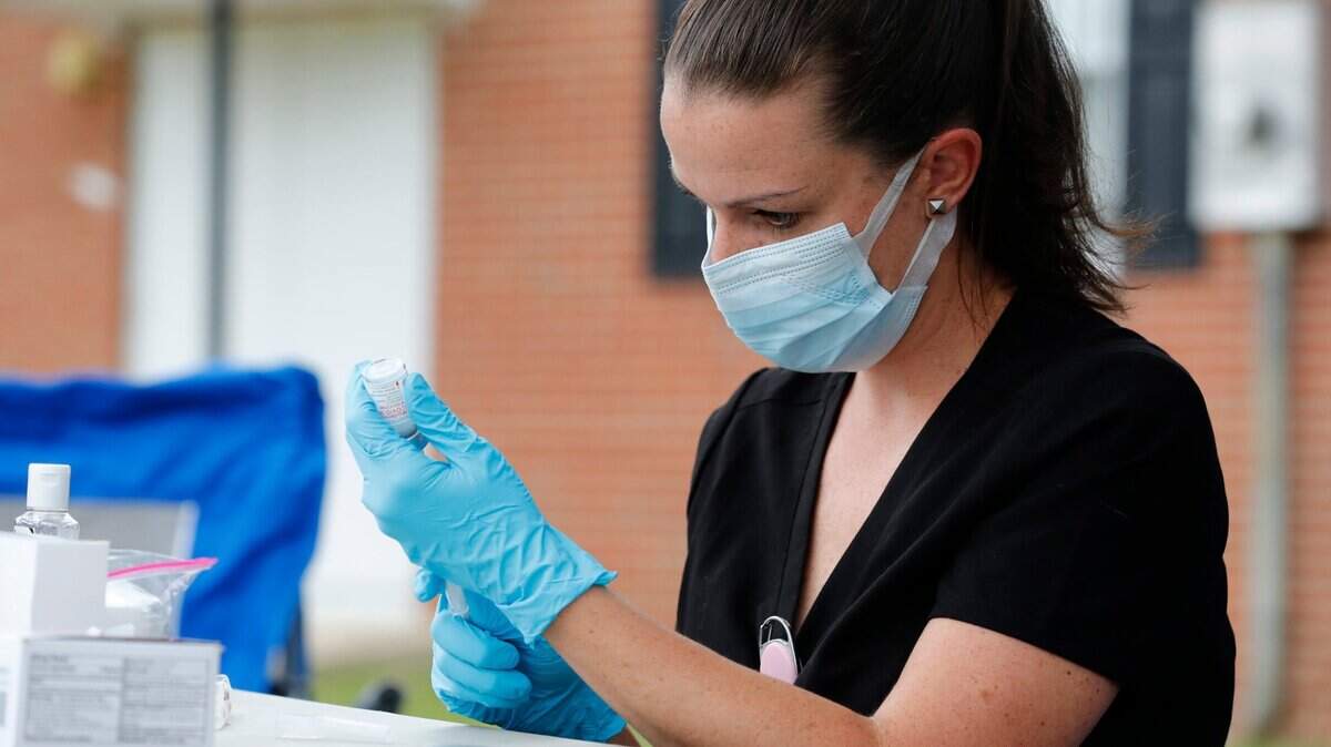 Erin Smith, family nurse practitioner with the Johnston County Public Health Department, prepares a Moderna Covid-19 vaccine shot during pop up vaccine clinic in Smithfield, N.C. on June 8, 2021.