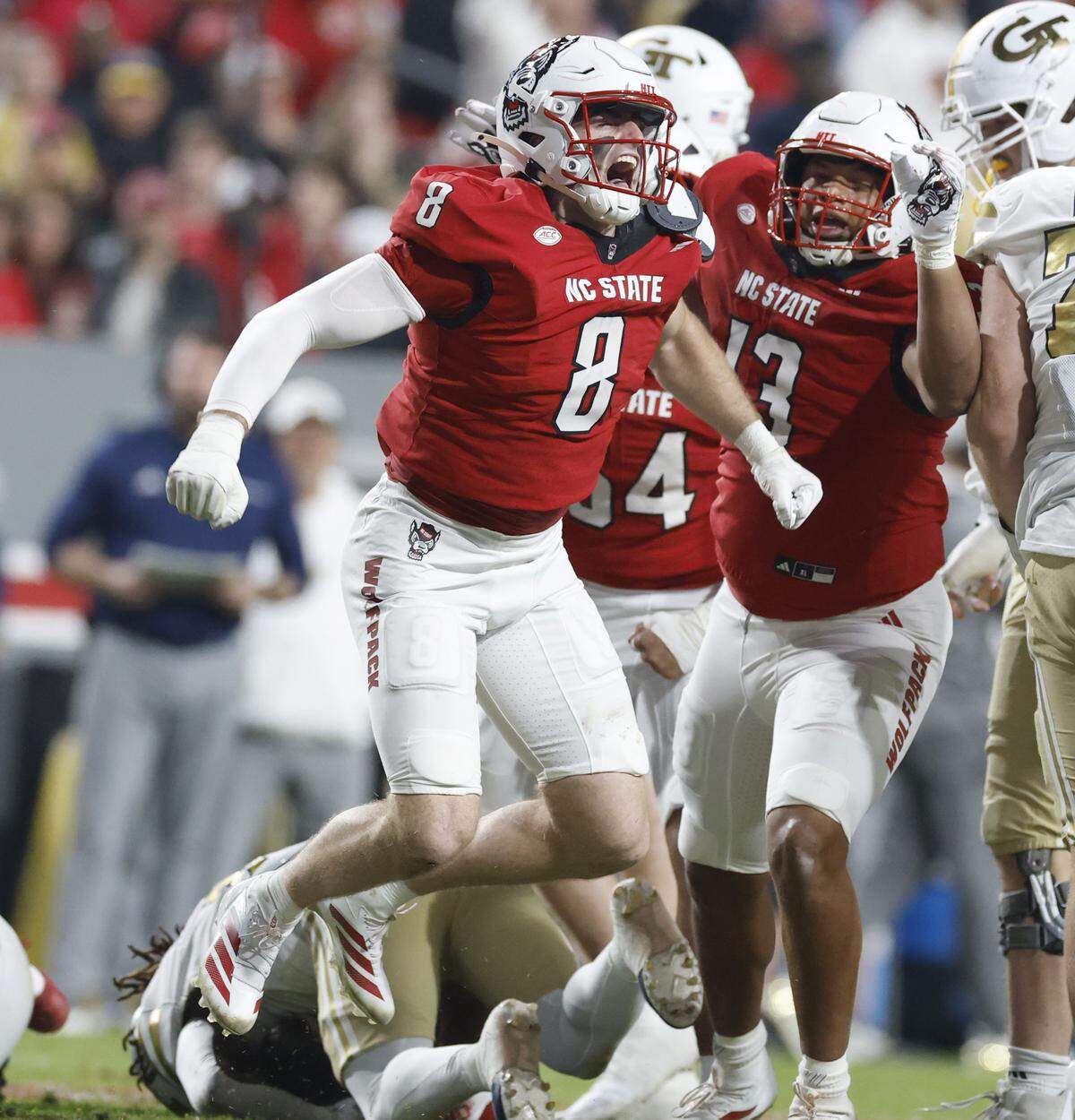 N.C. State’s Cian Slone (8) celebrates stopping Georgia Tech running back Jamal Haynes for a loss during the first half of N.C. State’s game against Georgia Tech at Carter-Finley Stadium in Raleigh, N.C., Saturday, Nov. 1, 2025.