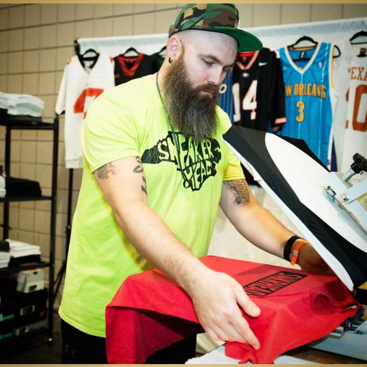 Andrew Rohman presses shirts at the Kickback Sneaker Expo for his company Unkl Drew’s.