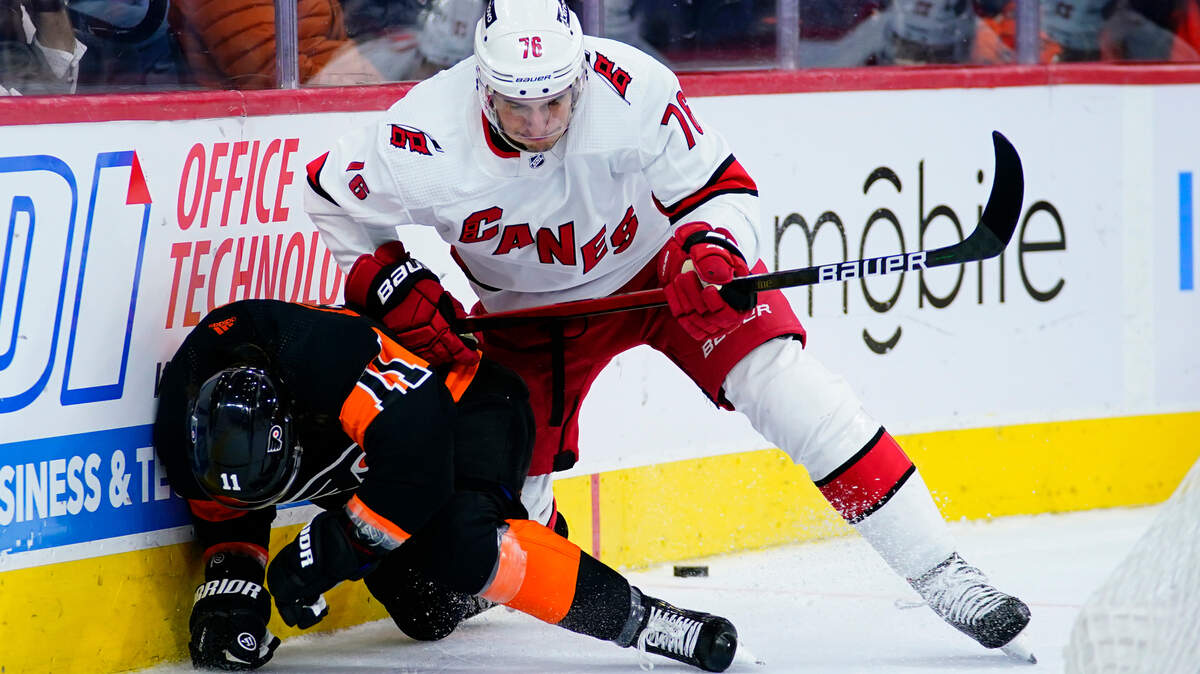 Carolina Hurricanes’ Brady Skjei, right, collides with Philadelphia Flyers’ Travis Konecny during the second period of an NHL hockey game, Friday, Nov. 26, 2021, in Philadelphia. (AP Photo/Matt Slocum)
