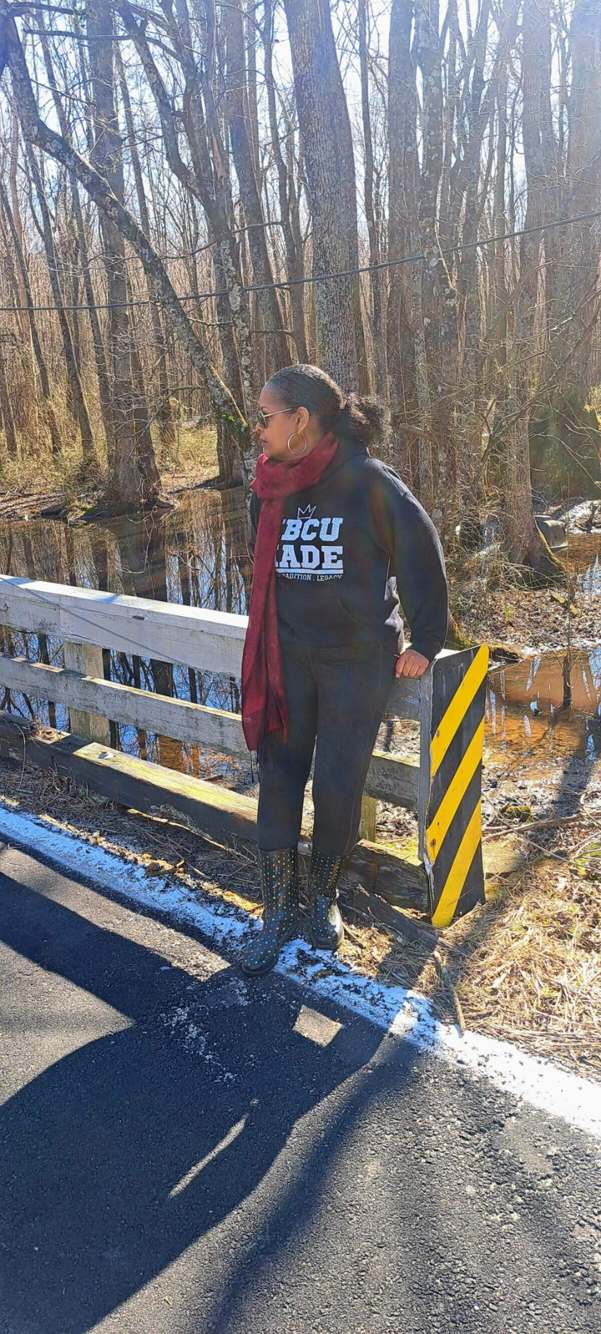Shelia Moses stands on the bridge in Rich Square near where her brother is thought to have disappeared and is still missing after 14 years.