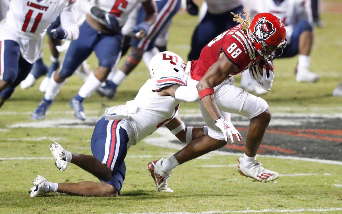 N.C. State wide receiver Devin Carter (88) tries break free from Liberty cornerback Chris Megginson (4) after making a catch during the first half of N.C. State’s game against Liberty at Carter-Finley Stadium in Raleigh, N.C., Saturday, Nov. 21, 2020.