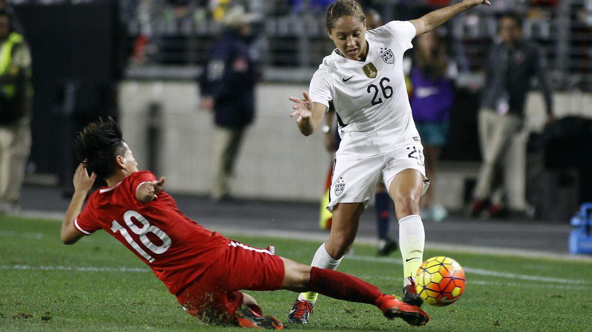 In this Dec. 13, 2015, file photo, China's Han Peng (18) slides in to knock the ball away from United States' Jaelene Hinkle during the second half of an international friendly soccer match, in Glendale, Ariz. Hinkle revealed she decided not to play for the U.S. women's national team last year because her Christian faith prevented her from wearing a jersey that commemorated LGBTQ Pride Month. Hinkle revealed the reason for her decision last June in an interview posted Wednesday, May 30, 2018, on The 700 Club website. (AP Photo/Ralph Freso, File)