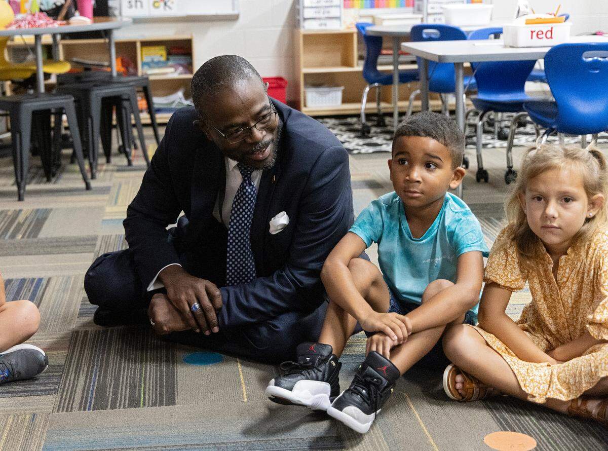 New Wake County Superintendent Robert Taylor sits with students during a tour of Rolesville Elementary School on his first day on the job, Monday, Oct. 2, 2023, in Rolesville, N.C.