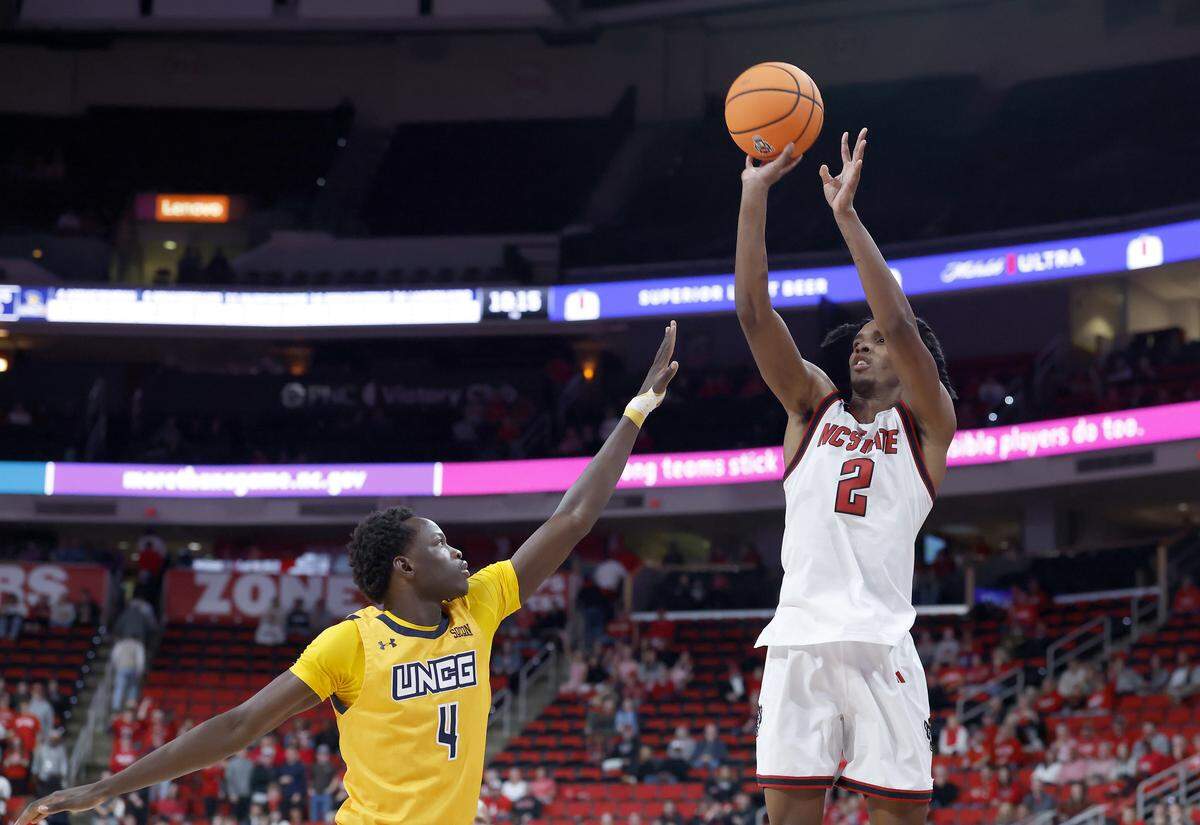 N.C. State’s Paul McNeil, Jr. shoots over UNC Greensboro’s Assane Mandian during the second half of the Wolfpack’s 110-64 win on Wednesday, Nov. 12, 2025, at Lenovo Center in Raleigh, N.C.