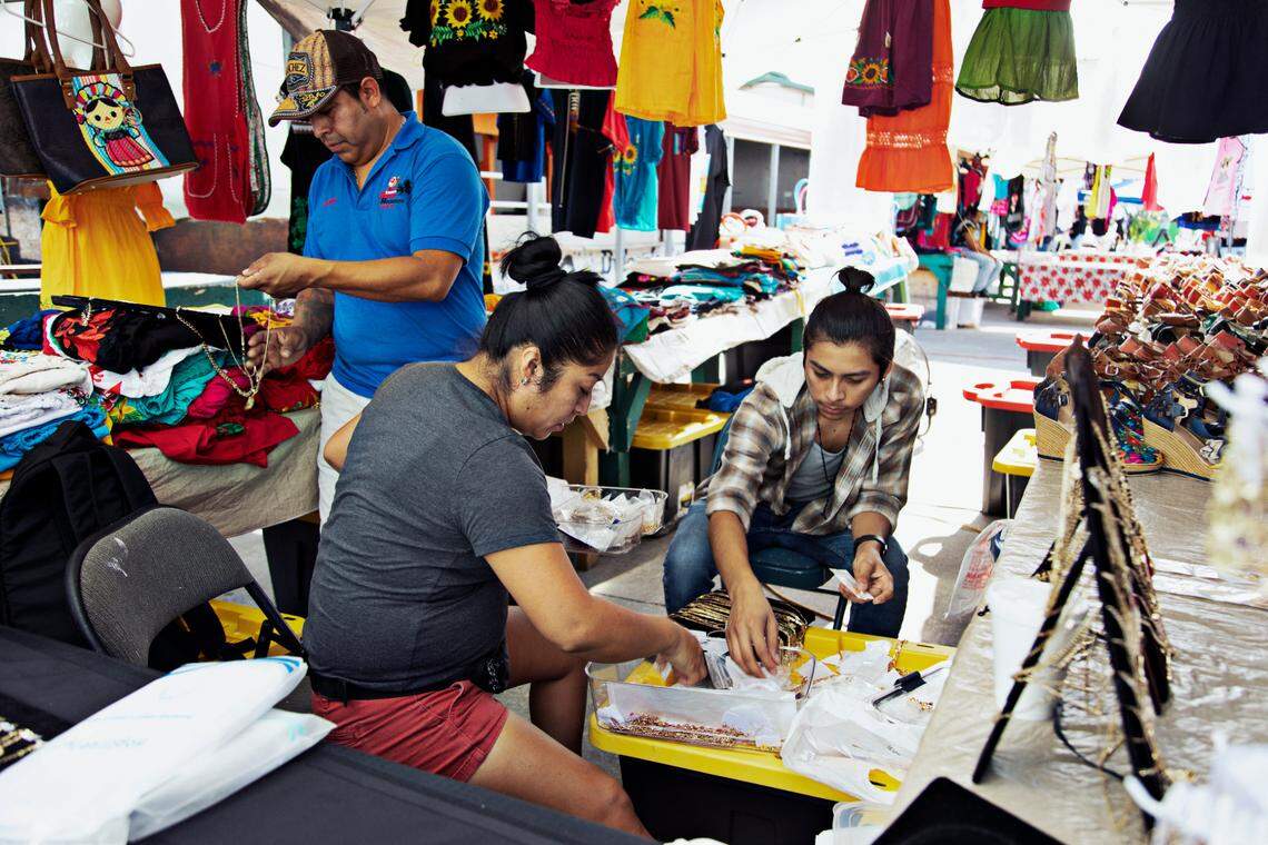From left, Yadira Sanchez, José Fiscal and their son, Michael Oliverio-Sanchez, set up the jewelry for their booth, Yadi’s Store, at the Durham Green Flea Market on Saturday, Sept. 18, 2021. North Carolina’s fast growth and increasing political influence is largely due to Hispanic people, who made up a massive chunk of the state’s growth from 2010 to 2020.