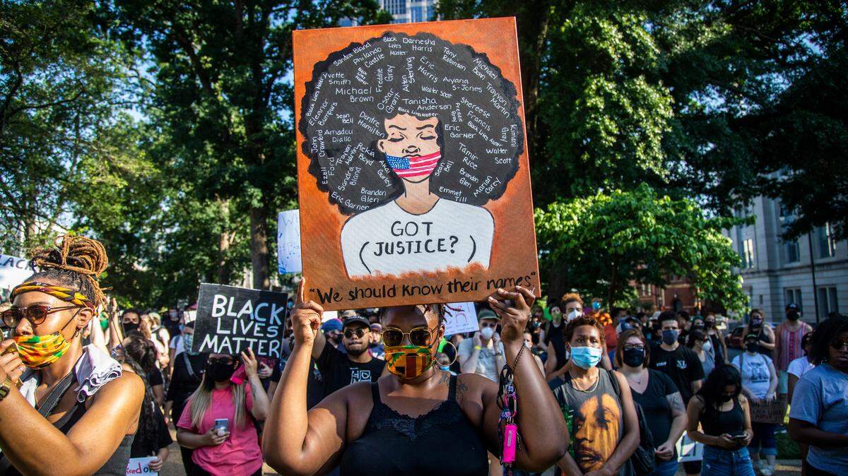 During the pandemic Black and Brown Americans faced the additional stress of dealing with a rise in racism. In this June 7, 2020 photo, Keisha Swain marches in peaceful protest in downtown Raleigh against police misconduct and systemic racism.