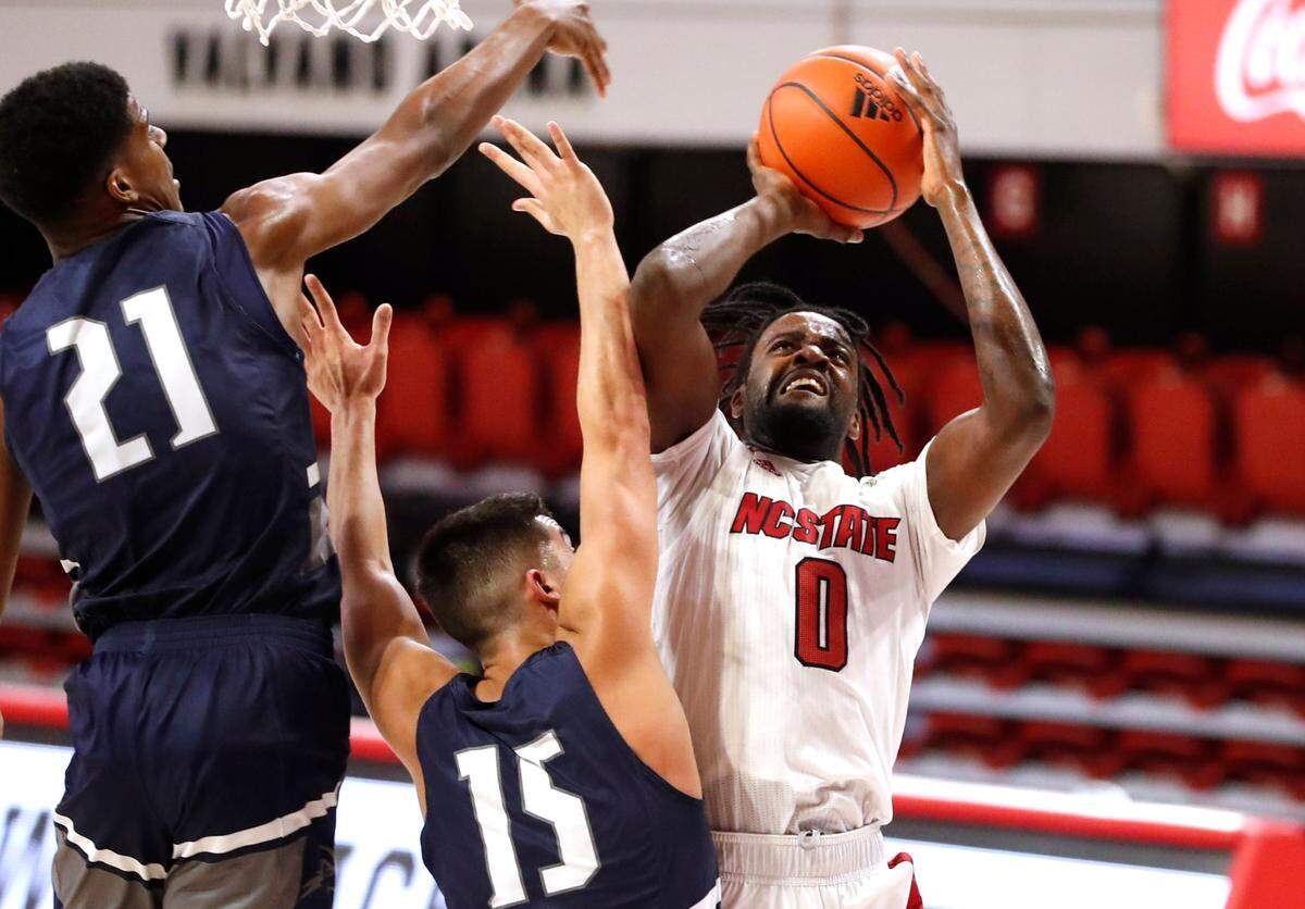 N.C. State’s D.J. Funderburk (0) shoots as North Florida’s Jose Placer (15) and Jonathan Aybar (21) defend during the second half of N.C. State’s 86-51 victory over North Florida in the Mako Medical Wolfpack Invitational at Reynolds Coliseum in Raleigh, N.C., Friday, Nov. 27, 2020.