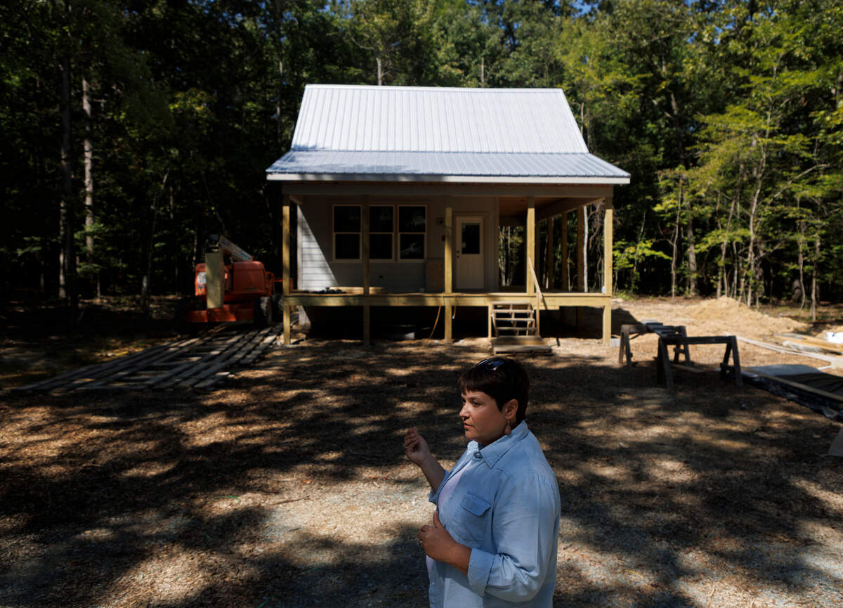 Second Act Arms co-owner Mandy Locke stands outside of a home under construction at the Alamance County farm on Tuesday, Sept. 10, 2024. Locke, along with her husband Alex Granados, is partnering with the North Carolina Center on Actual Innocence to build two homes at the farm that will help support exonerees as they re-integrate into society.