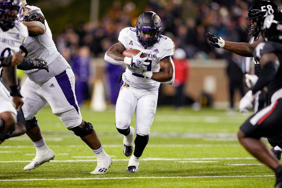 East Carolina running back Marlon Gunn Jr. (21) carries during the second half of the team’s NCAA college football game against Cincinnati, Friday, Nov. 11, 2022, in Cincinnati. (AP Photo/Jeff Dean)