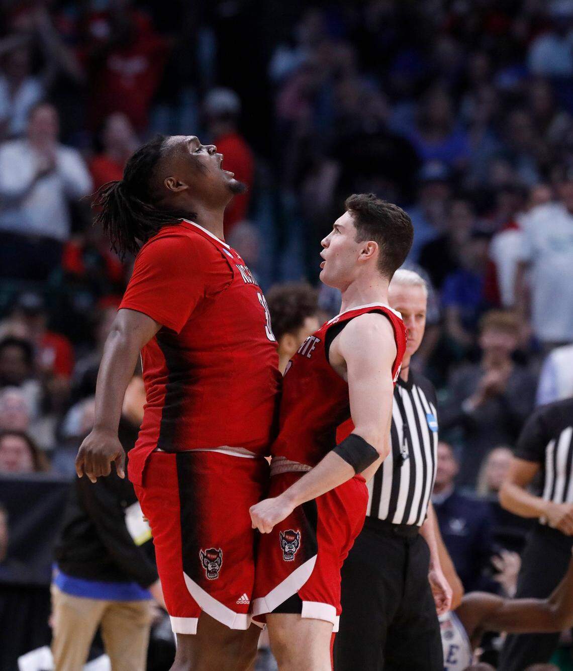 N.C. State’s DJ Burns, Jr. and Michael O’Connell celebrate in the second half of the Wolfpack’s 76-64 win over Duke in the NCAA Tournament Elite Eight on Sunday, March 31, 2024, at American Airlines Center in Dallas, Texas.