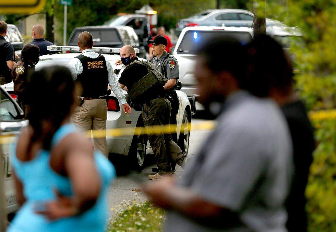 Law enforcement investigate the scene of a police involved shooting, Wednesday, April 21, 2021, in Elizabeth City, N.C. A North Carolina sheriff says the deputy who shot and killed a man while serving a search warrant has been put on leave pending an investigation. Pasquotank County Sheriff Tommy Wooten II did not identify the deputy who fired the shot Wednesday.