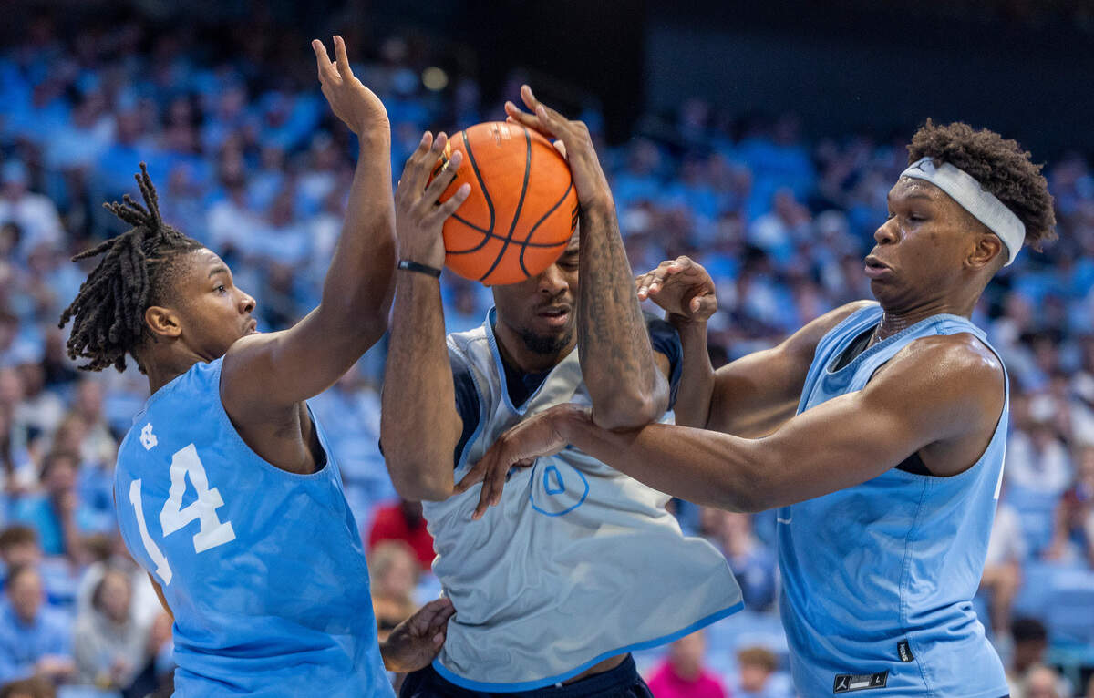 North Carolina’s Ty Claude (0) is trapped by Russell Hawkins (14) and Ven-Allen Lubin (22) in the second half during the Tar Heels’ Blue vs. White scrimmage on Saturday, October 12, 2024 at the Smith Center in Chapel Hill, N.C.