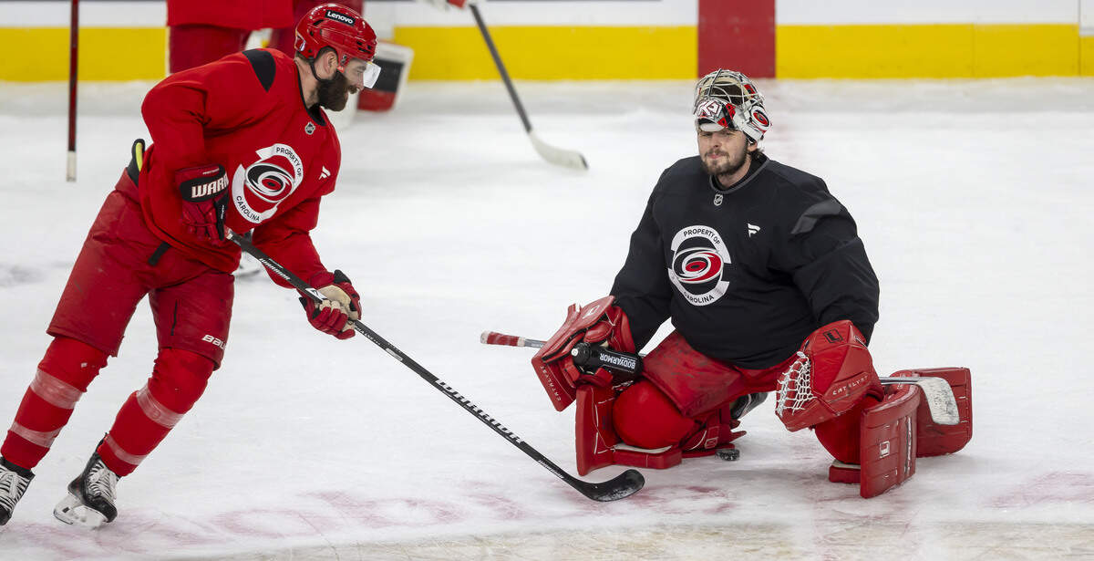 Carolina Hurricanes left wing Jordan Martinook (48) confers with goalie Pyotr Kochetkov (52) during practice on Monday, June 8, 2026 at T-Mobile Arena in Las Vegas, NV.