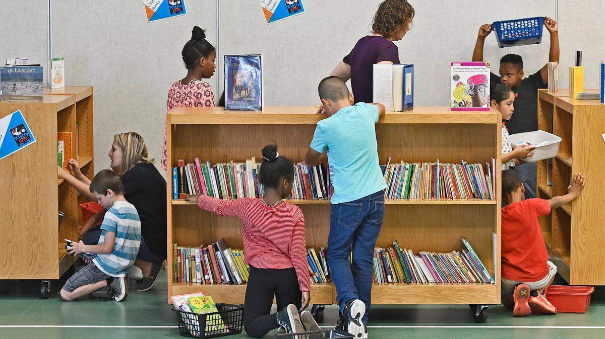Third graders search for books during a reading event in Garner, N.C., Thursday, May 11, 2017.