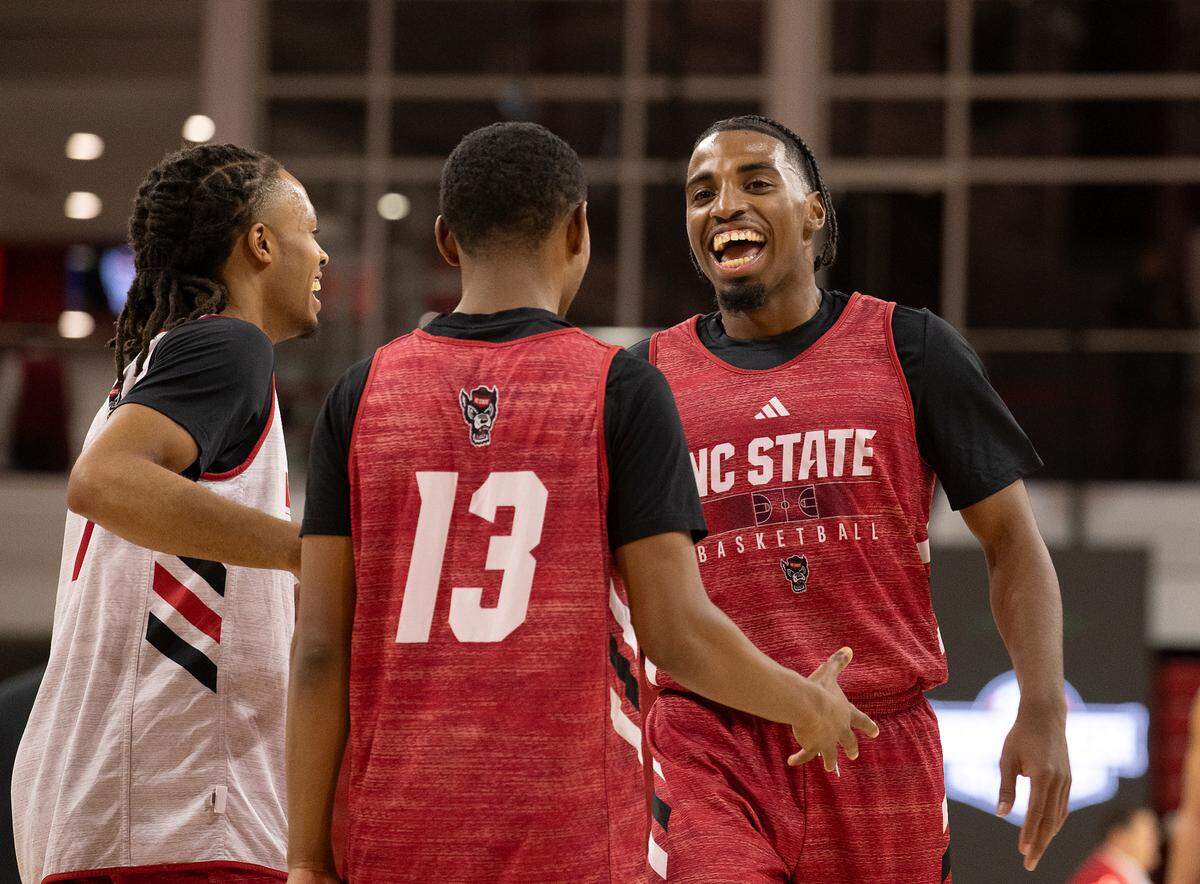 Marcus Hill is congratulated by teammates Breon Pass and KJ Keatts following a scrimmage during the Primetime with the Pack preseason event on Friday, Oct. 25, 2024, at Reynolds Coliseum in Raleigh, N.C.