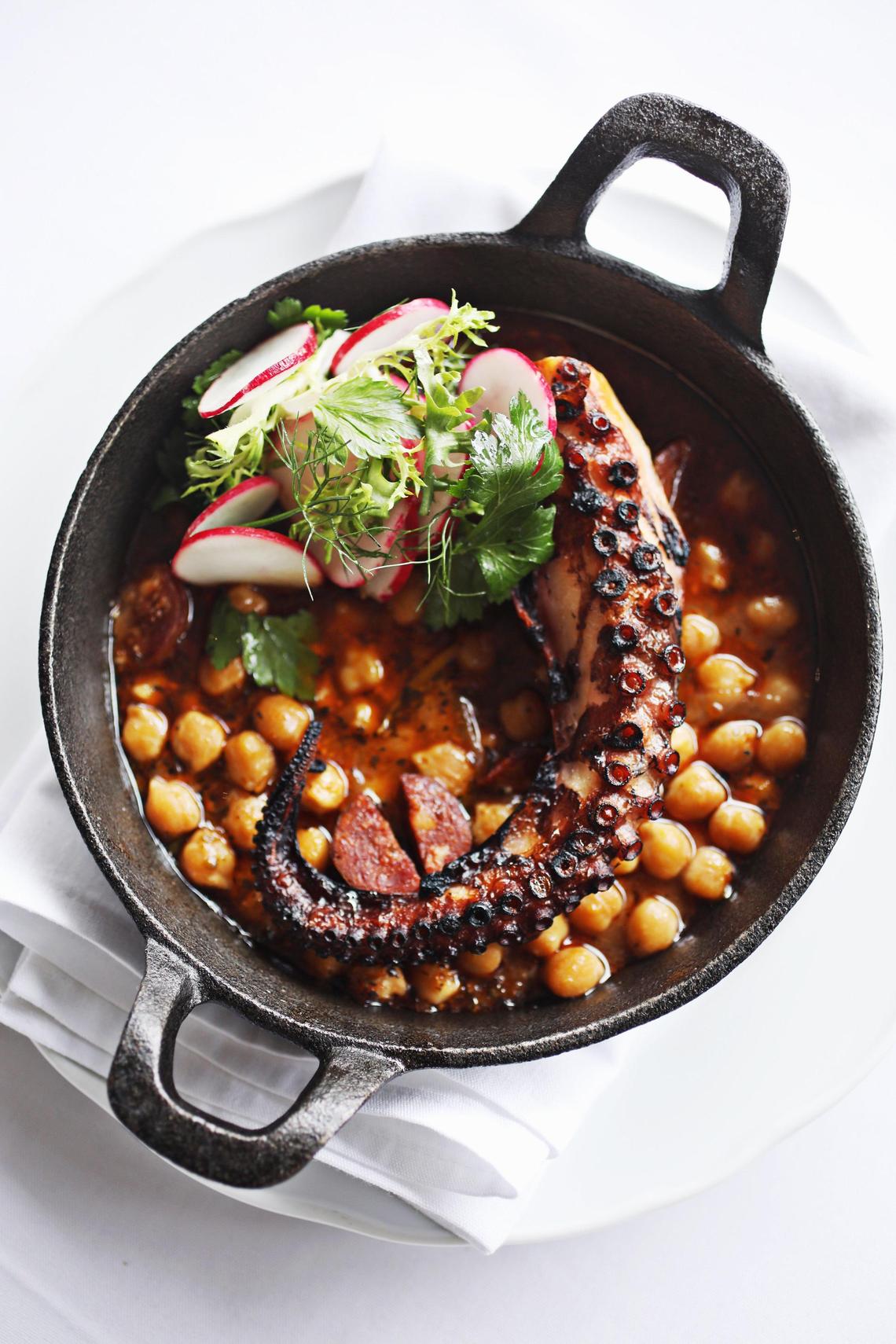 Parizade’s Grilled Portuguese octopus is served over stewed chickpeas, chorizo with shaved radish.