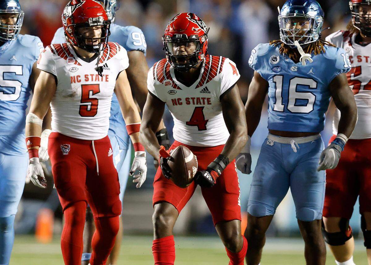 N.C. State wide receiver Porter Rooks (4) celebrates after making a first down during the second half of N.C. State’s 30-27 overtime victory over UNC at Kenan Stadium in Chapel Hill, N.C., Friday, Nov. 25, 2022.