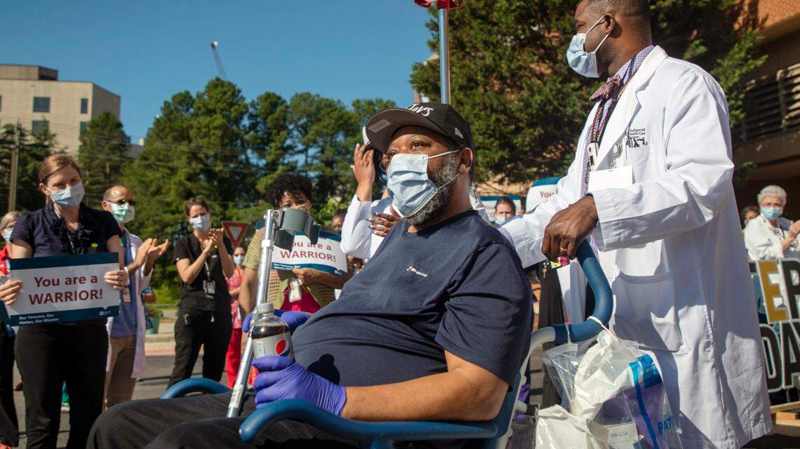 Ollie Hendricks, an Army veteran, pauses to look at the sky while departing from Durham VA Health Care System hospital through a tunnel of medical staff to celebrate his recovery from COVID-19, on Friday, Jun. 26, 2020, in Durham, N.C.