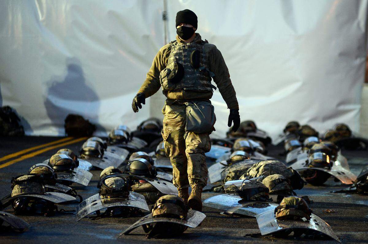 A member of the National Guard stands amidst riot gear in Washington on Wednesday morning, Jan. 20, 2021, hours before the presidential inauguration of Joe Biden.