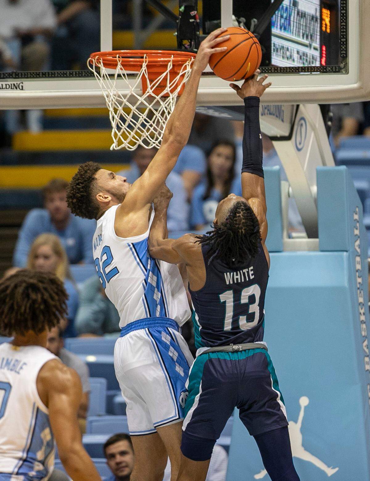 North Carolina’s Pete Nance (32) blocks a shot by UNC Wilmington’s Trazarien White (13) in the second half on Monday, November 7, 2022 at the Smith Center in Chapel Hill, N.C.