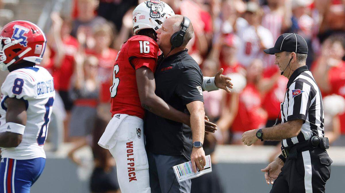N.C. State head coach Dave Doeren chest bumps quarterback CJ Bailey (16) during the second half of N.C. State’s 30-20 victory over LA Tech at Carter-Finley Stadium in Raleigh, N.C., Saturday, Sept. 14, 2024.