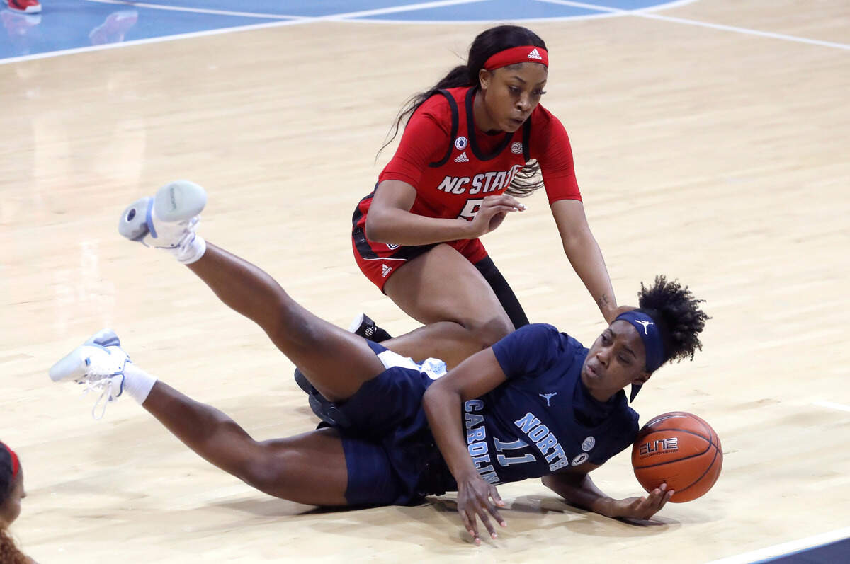 North Carolina’s Ariel Young (11) dives after a loose ball with N.C. State’s Jada Boyd (5) during the first half of N.C. State’s game against UNC at Carmichael Arena in Chapel Hill, N.C., Sunday, February 7, 2021.