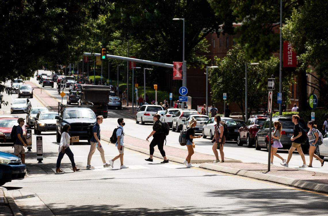 N.C. State students cross Hillsborough Street on the first day of classes for the fall semester, on Monday, Aug. 16, 2021, in Raleigh, N.C.