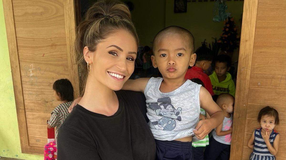 Carolina Hurricanes TV host Hanna Yates holds a 3-year-old at the New Vision for Life Foundation, an orphanage for Hill Tribe Children in Chiang Rai, Thailand.
