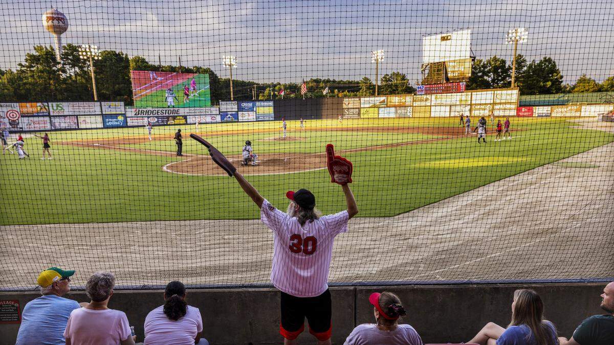 Carolina Mudcats season ticket holder Chad Doherty, of Raleigh, cheers during the seventh-inning stretch at a recent game against the Kannapolis Cannon Ballers on Tuesday, July 22, 2025, at Five County Stadium in Zebulon, N.C.
