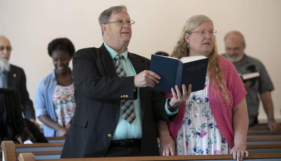 Brookhaven Baptist Church members Mark and Debbie Allen sing during the 11 a.m. worship service on Sunday, May 17, 2020 in Greensboro, N.C. More than two dozen members attended, following distancing guidelines. Masks and hand sanitizers were made available to the congregation.