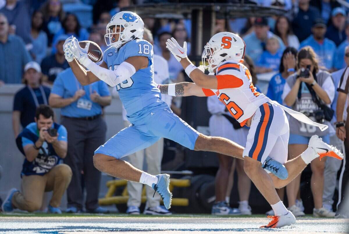 North Carolina’s Bryson Nesbit (18) pulls in a 23-yard pass from quarterback Drake Maye for a touchdown ahead of Syracuse’s Aman Greenwood (26) to give the Tar Heels’ a 17-0 lead in the second quarter on Saturday, October 7, 2023 at Kenan Stadium in Chapel Hill, N.C.