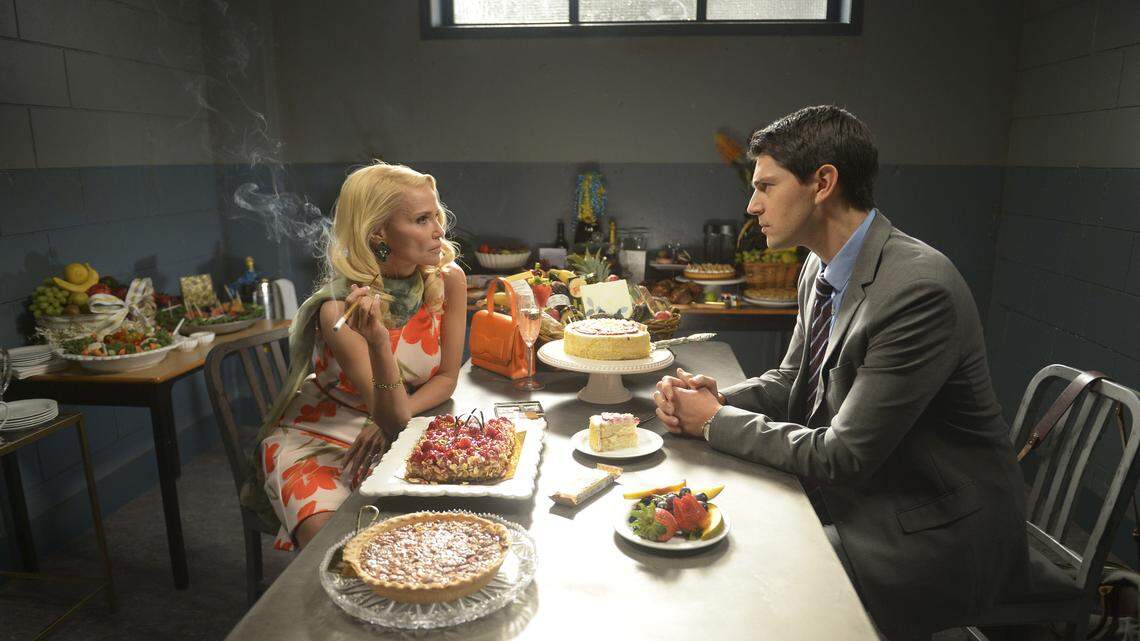 Kristin Chenoweth, left, as Lavinia Peck-Foster, talks to her attorney Josh Segal (Nicholas D'Agosto) from her jail cell in NBC's "Trial & Error: Lady, Killer."