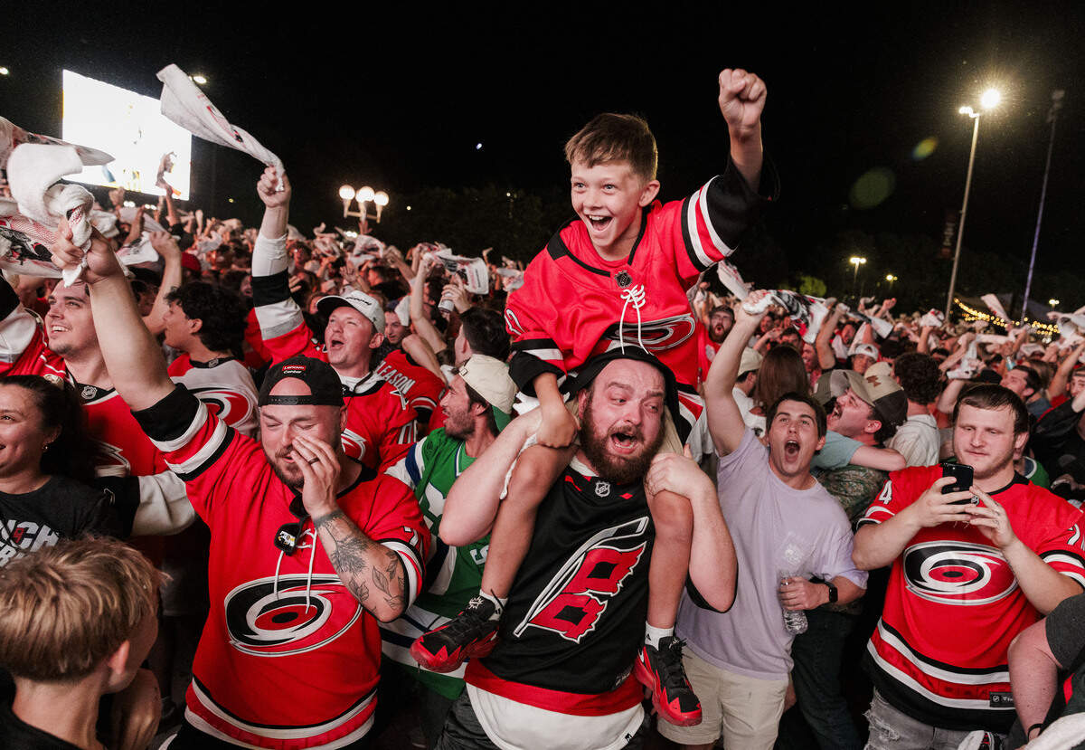 James White celebrates on the shoulders of a family friend, Austin Rybkin, as the Carolina Hurricanes score their third point against the Vegas Golden Knights during a watch party for game 5 of the Stanley Cup finals outside the Lenovo Center on June 11, 2026, in Raleigh, North Carolina.