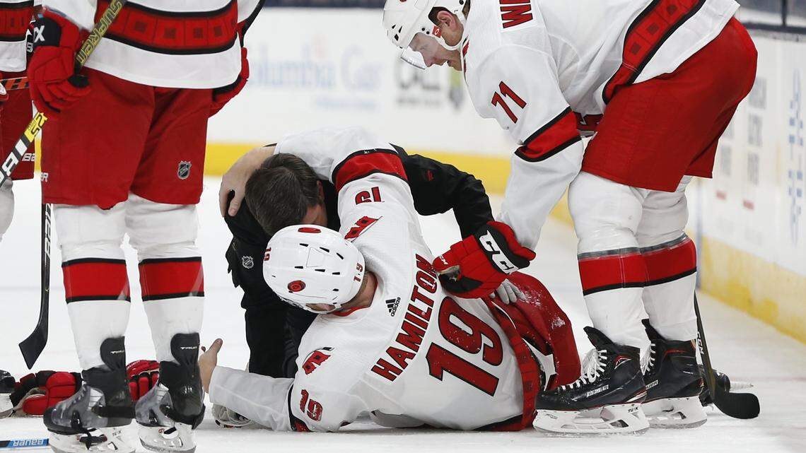 Carolina Hurricanes’ head athletic trainer Doug Bennett attends to Dougie Hamilton after Hamilton was injured in the second period of an NHL hockey game against the Columbus Blue Jackets, Thursday, Jan. 16, 2020, in Columbus, Ohio.
