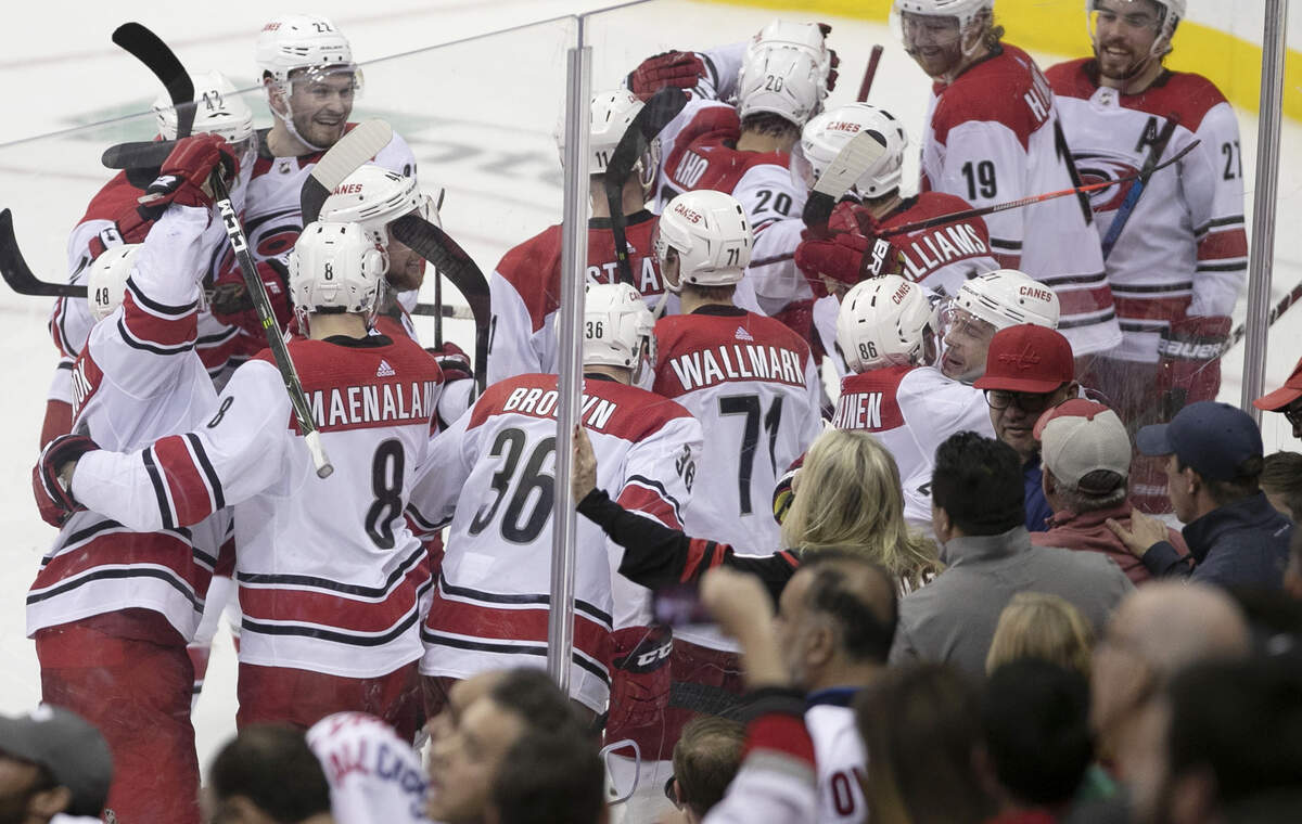 The Carolina Hurricanes surround Brock McGinn (23) he scored the game winning goal in the second overtime to defeat the Washington Capitals 4-3 clinching their series with the Capitals on Wednesday, April 24, 2019 at Capital One Arena in Washington, D.C.