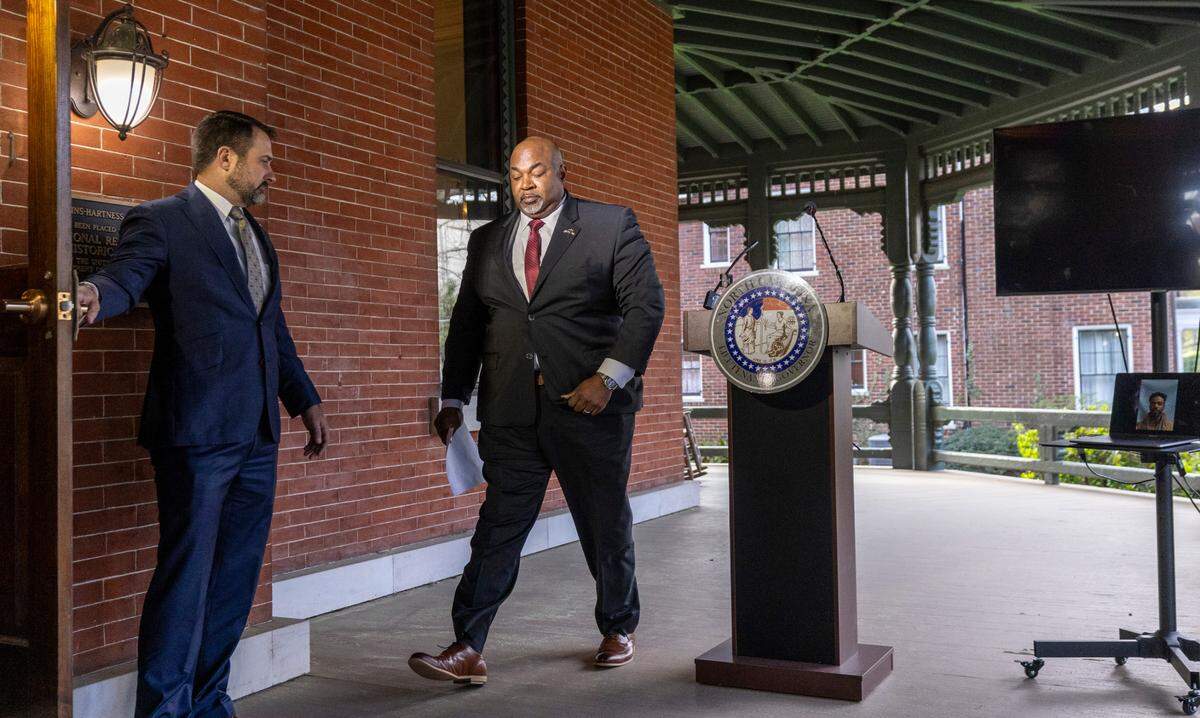 North Carolina Republican Lt. Gov. Mark Robinson, a gubernatorial candidate, walks from the lectern during a press conference at the Office of the Lieutenant Governor in Raleigh on Monday, March 18, 2024. On the left is his then-Chief of Staff Brian LiVecchi.