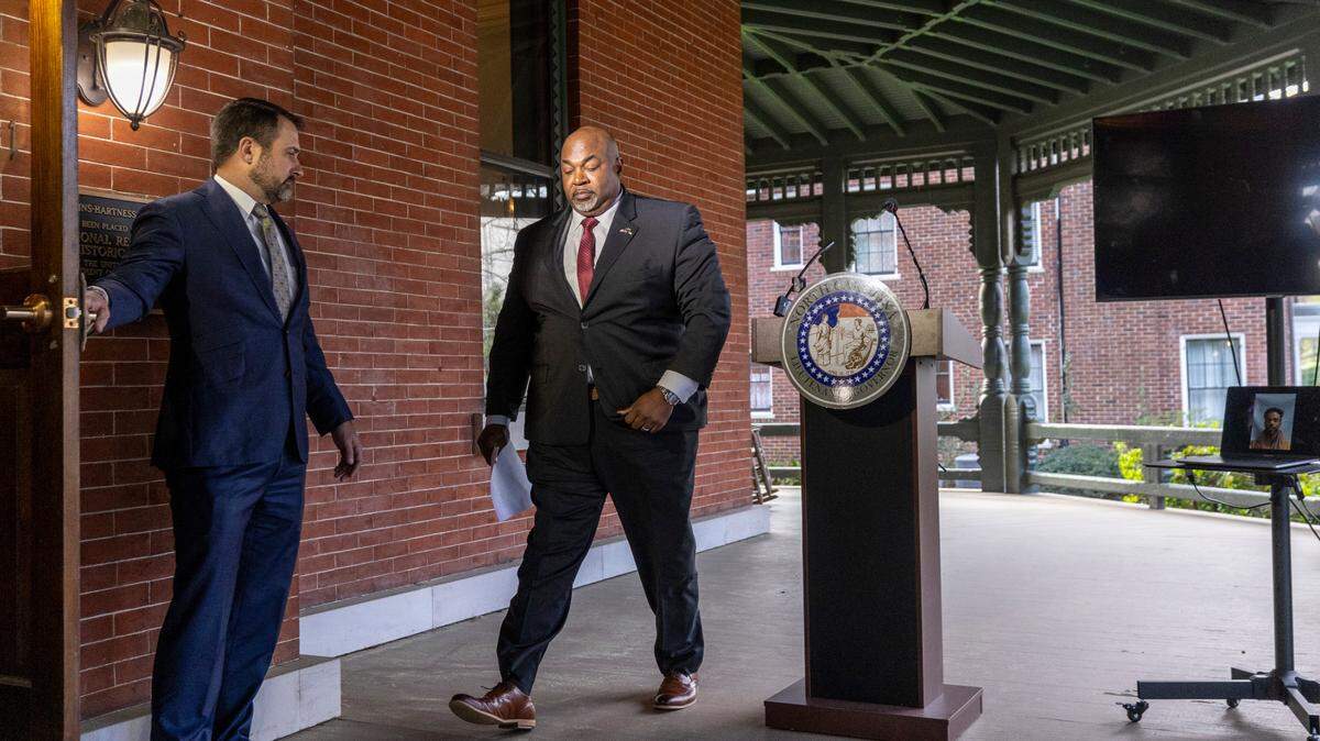 North Carolina Republican Lt. Gov. Mark Robinson, a gubernatorial candidate, walks from the lectern during a press conference at the Office of the Lieutenant Governor in Raleigh on Monday, March 18, 2024. Holding the door on the left is his then-Chief of Staff Brian LiVecchi. LiVecchi and three other key staff quit this week.