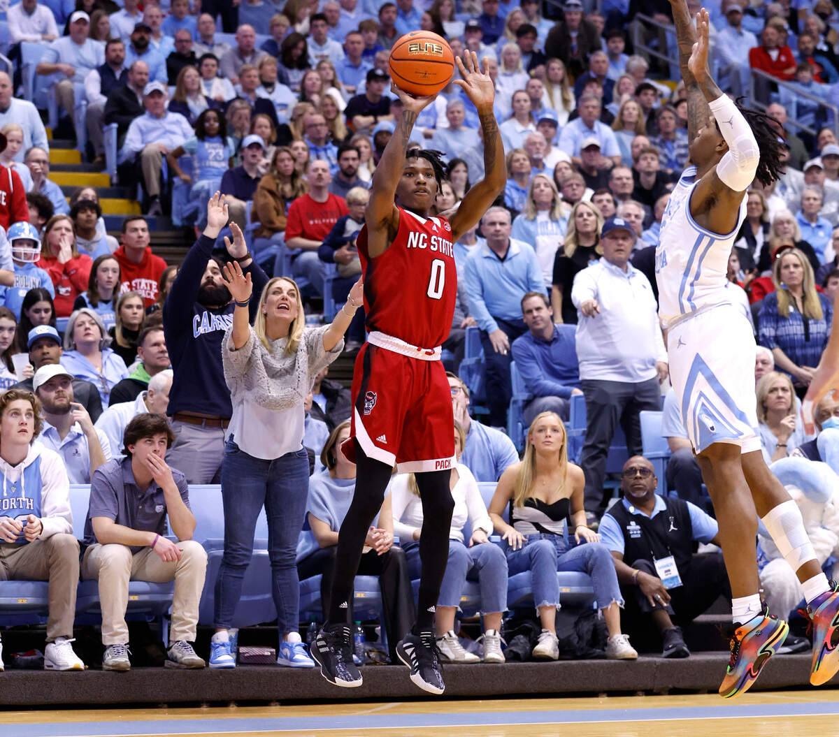 N.C. State’s Terquavion Smith (0) shoots as North Carolina’s Caleb Love (2) defends during the second half of UNC’s 80-69 victory over N.C. State at the Smith Center in Chapel Hill, N.C., Saturday, Jan. 21, 2023.