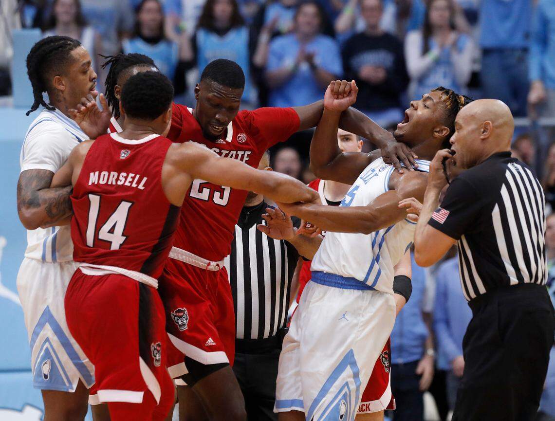 N.C. State’s Mohamed Diarra separates players after an altercation between N.C. State’s Casey Morsell and Elliot Cadeau during the second half of the Tar Heels’ 79-70 win on Saturday, March 2, 2024, at the Smith Center in Chapel Hill, N.C.